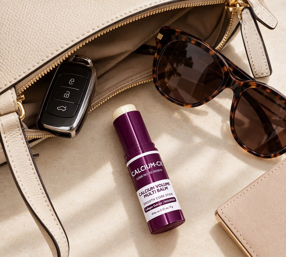 The Lift Stick in an open handbag with keys and sunglasses