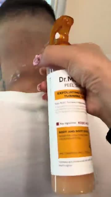 Spraying Peel Shot on the skin